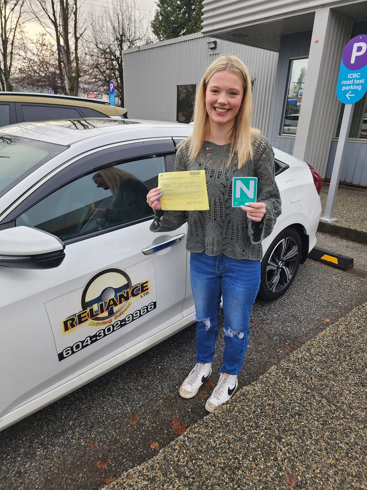 Happy student celebrating passing their road test with Reliance Driving School